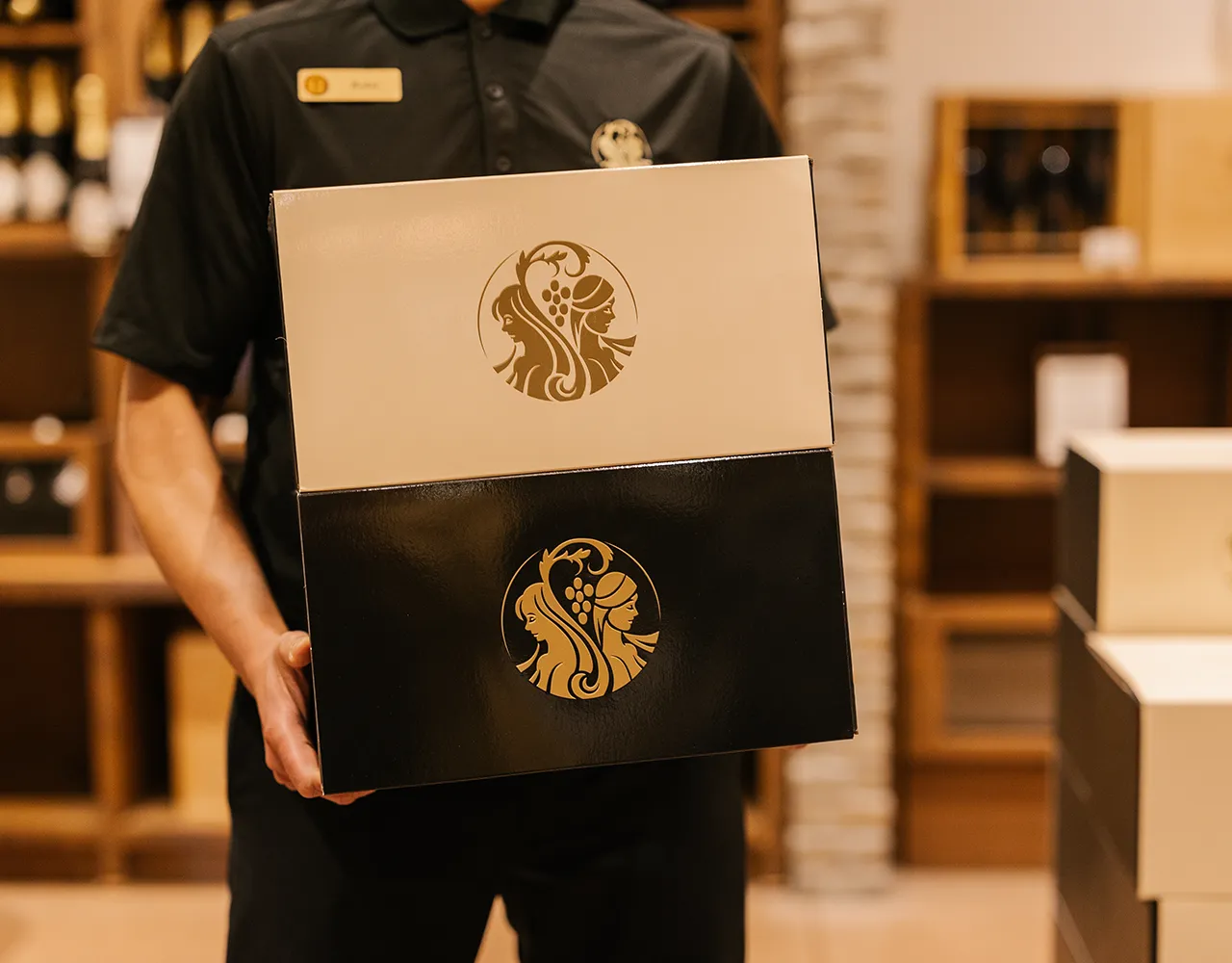 Person holding boxes of Two Sisters Wines ready to ship to a virtual Tasting customer.