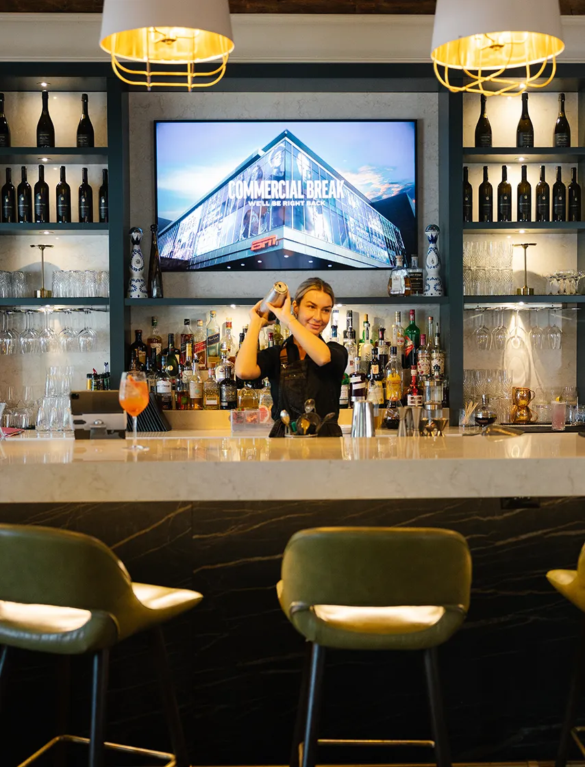 Bar staff shaking cocktails at 11th Post On Queen.
